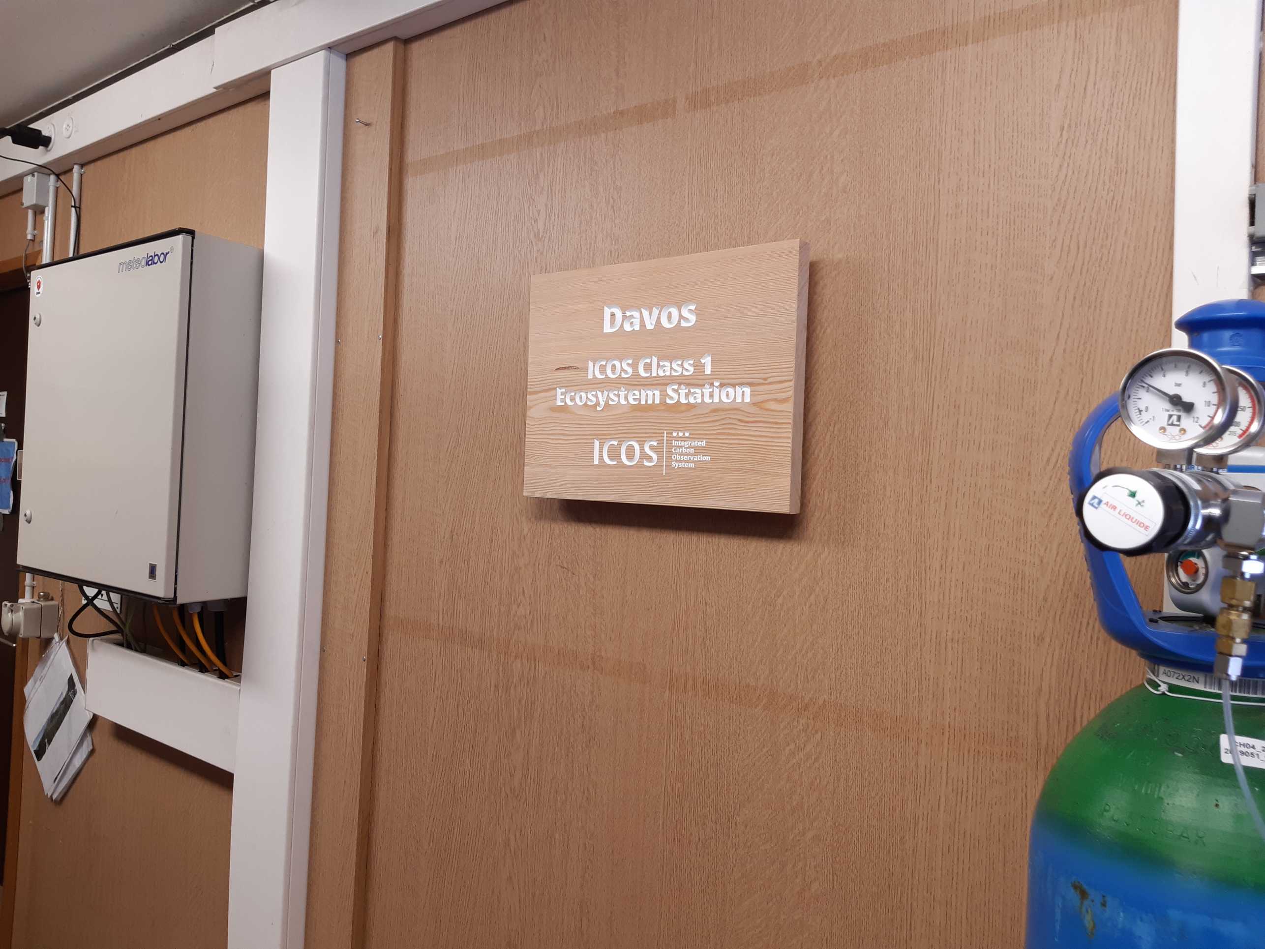 Wooden board saying "Davos ICOS Class 1 Ecosystem Station"