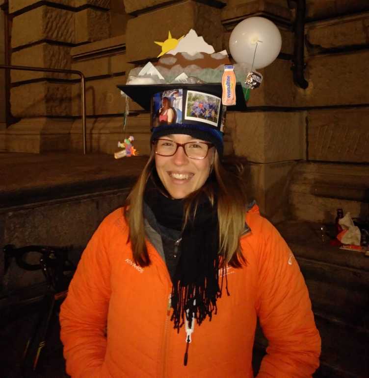 Doctoral student with doctoral hat made by colleagues